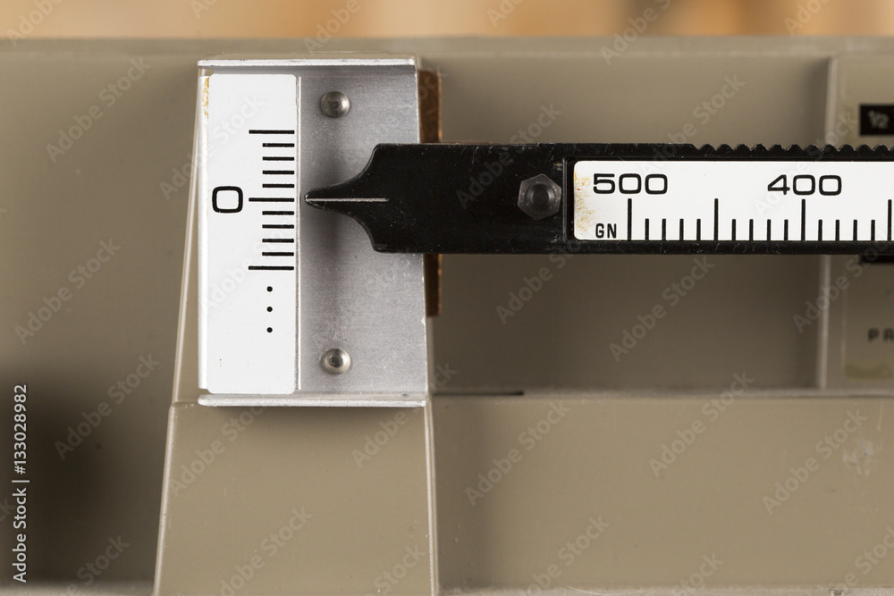 Macro Image of an Old Balance Scale - on Zero - photographed on an antique maple table in the Vertical orientation