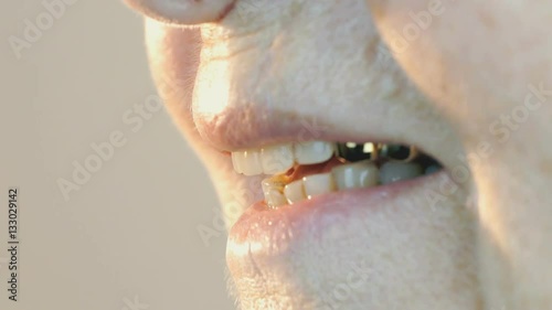 The old woman aged 80s smiling with false teeth. Close up photo