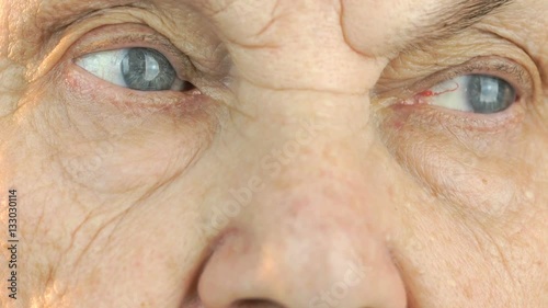 Elderly woman's face with disturbing look of face. Close up photo