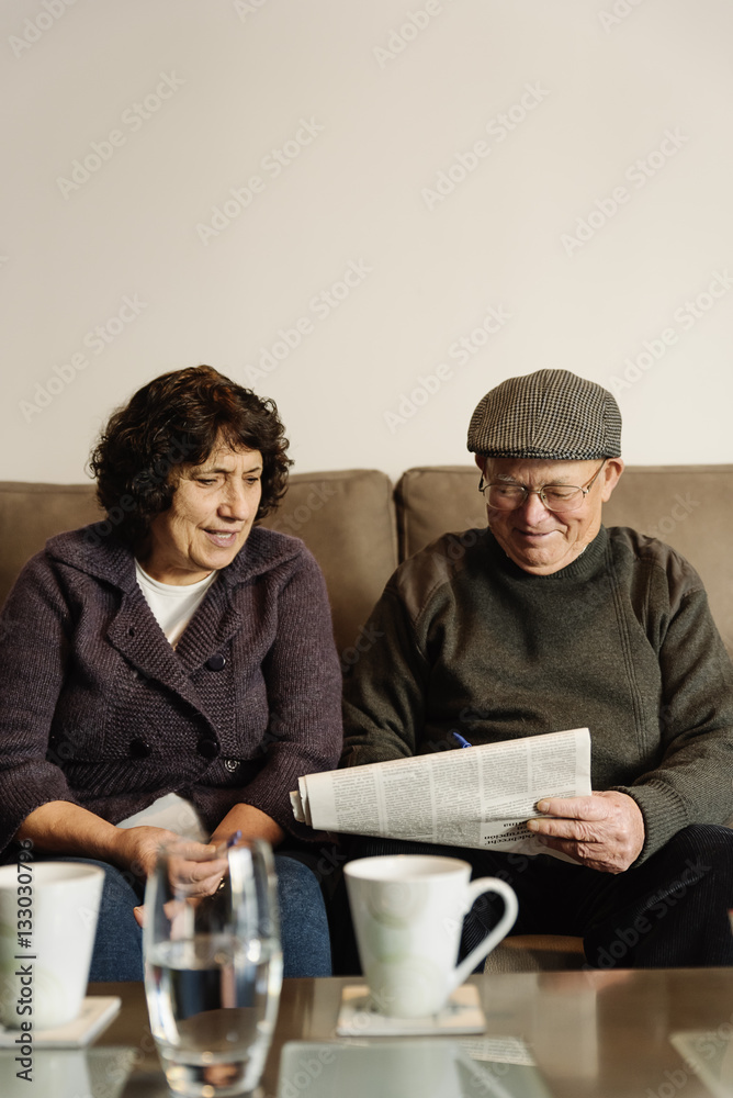 Elderly couple reading a newspaper. Elderly couple reading a newspaper.