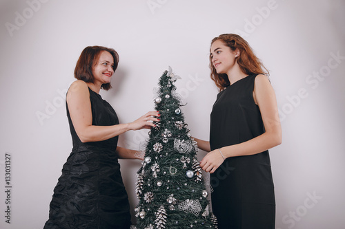Mom and daughter decorating Christmas tree