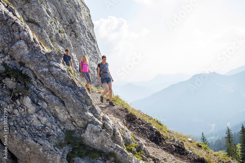 Group of friends hiking in mountain landscape