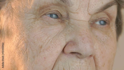 Old woman's face with disturbing look of face. Close up photo