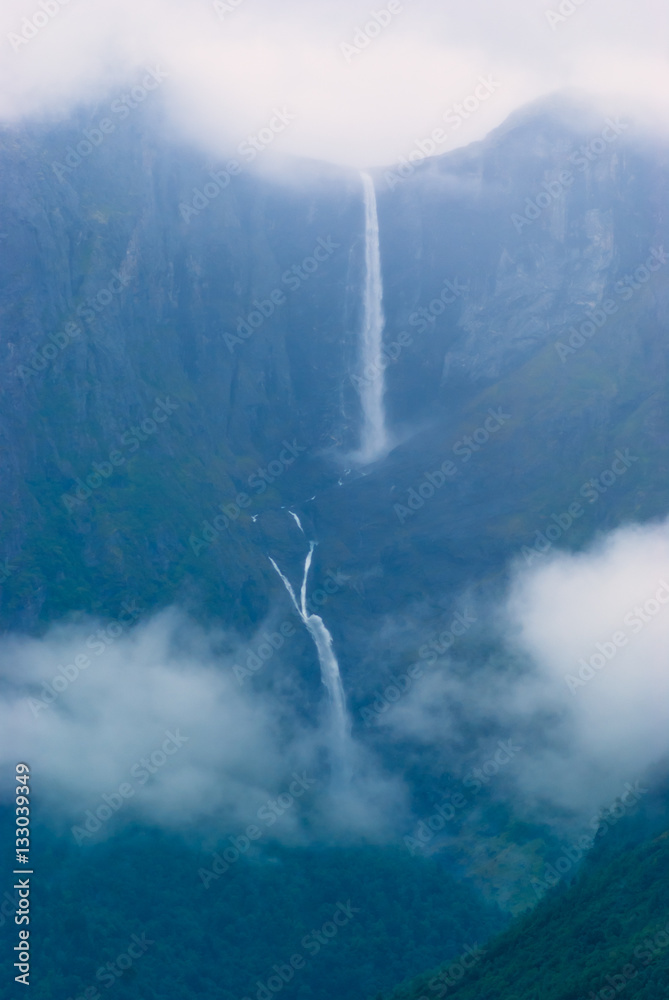 Fototapeta premium Landscape with views of the largest waterfall in the clouds. The county of More og Romsdal. Norway