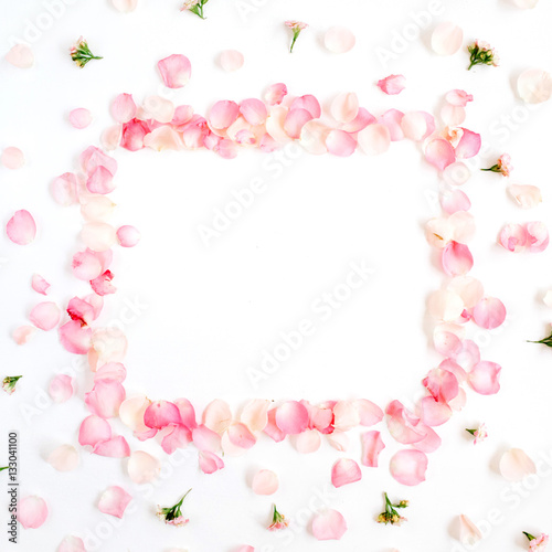 Frame made of pink roses petals on white background. Flat lay, top view. Valentine's background