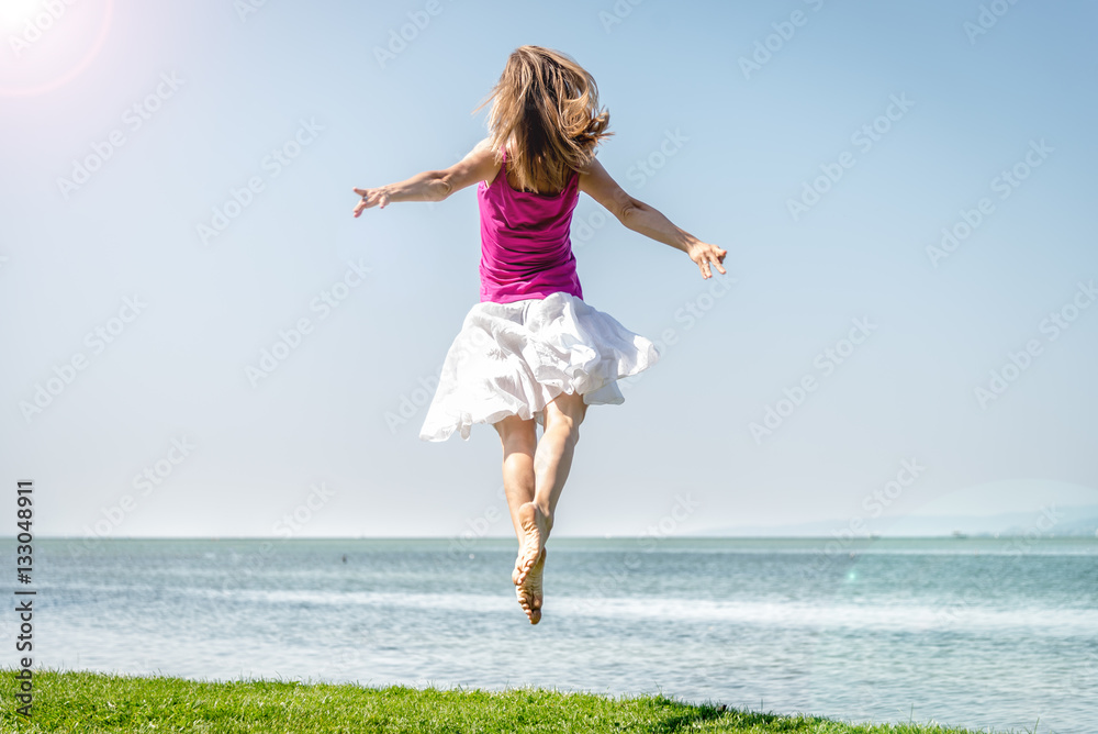 Girl jumping on the lake