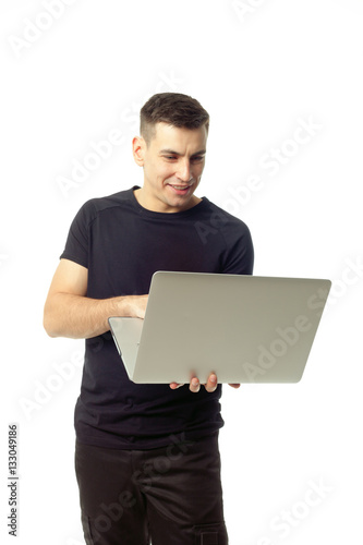 Portrait of smiling young man with laptop isolated