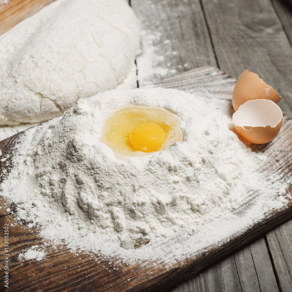 Handful of flour with egg yolks close up Handful of flour with egg yolks close up