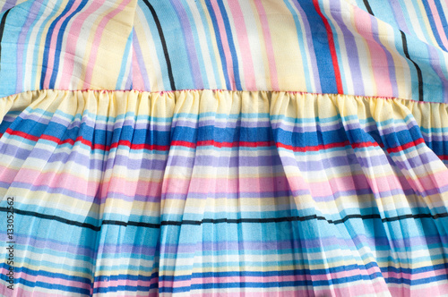 Pleated fabric. Sinii yellow red white stripes texture photo