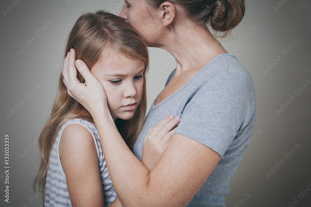sad daughter hugging his mother at home. sad daughter hugging his mother at home.