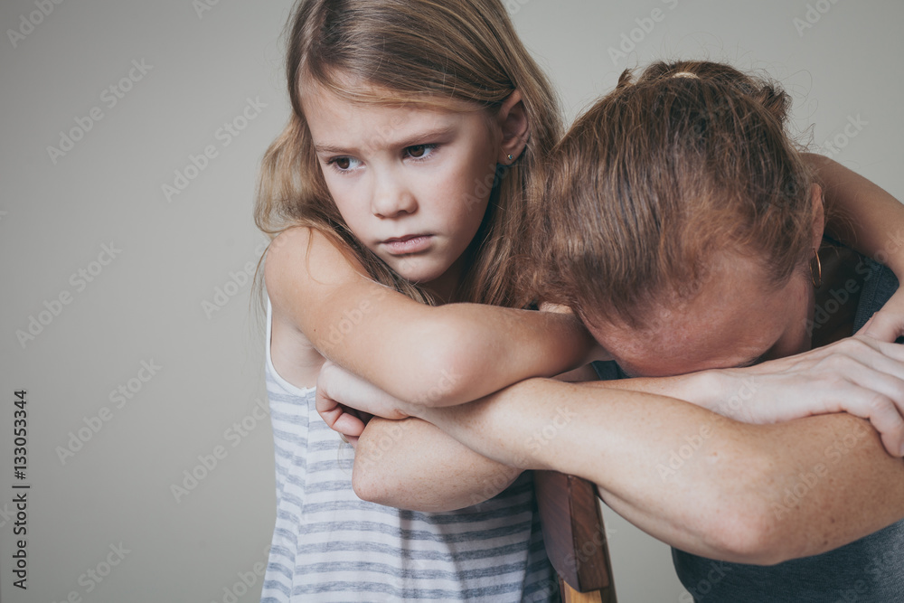sad daughter hugging his mother at home. sad daughter hugging his mother at home.