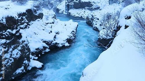 Barnafoss or Bjarnafoss, waterfall near Hraunfossar which burst out of Hallmundarhraun great lava plain, Reykholt, West Iceland. photo