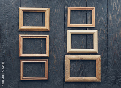old frames on wooden wall