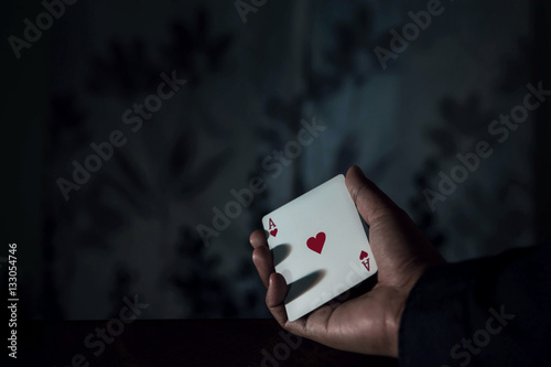 Ace Card in Hand, Chance or Risk of Love Concept, low-key lighting and selective focus on red heart