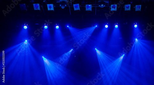 Blue rays of light through the smoke on stage. Theater performance. Lighting equipment