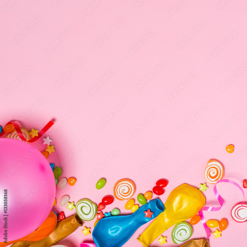 Celebration Flat lay. Candy with colorful party items on pink ba