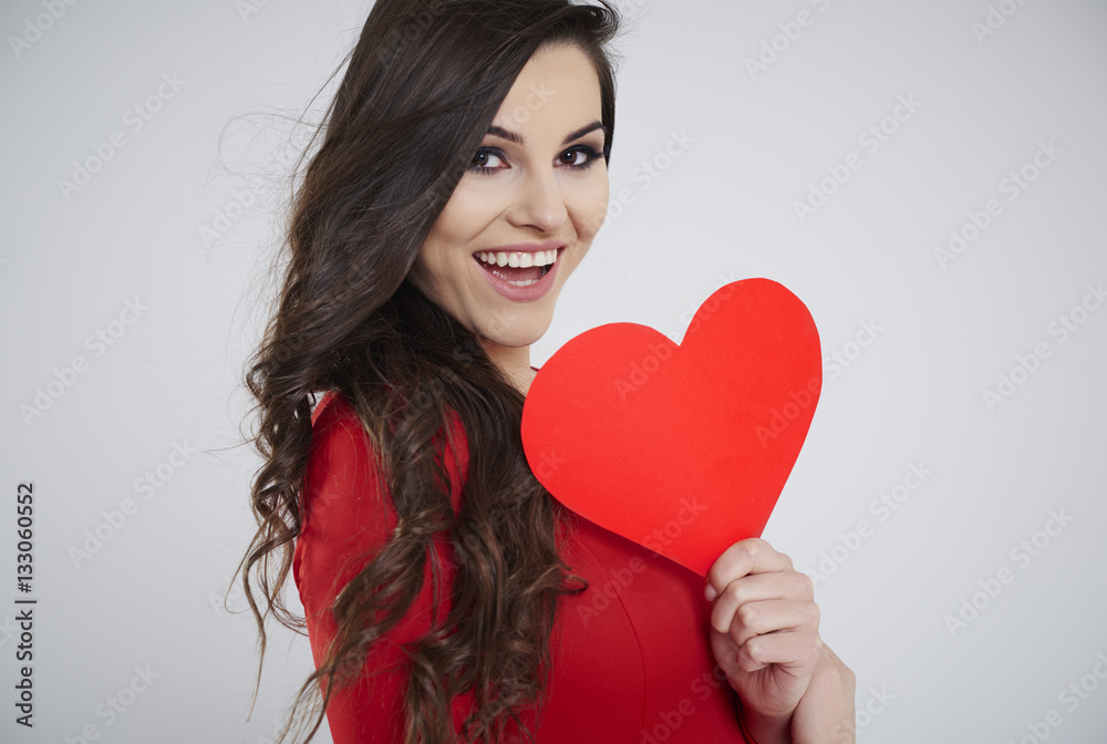 Close up of woman holding red paper heart . Close up of woman holding red paper heart .