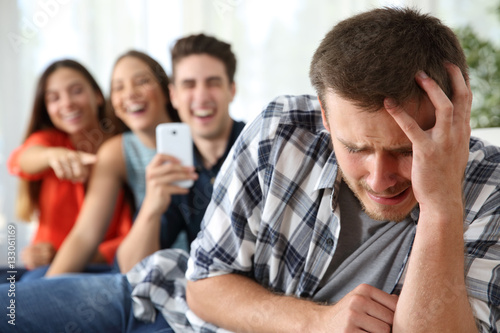 Friends bullying to a sad boy