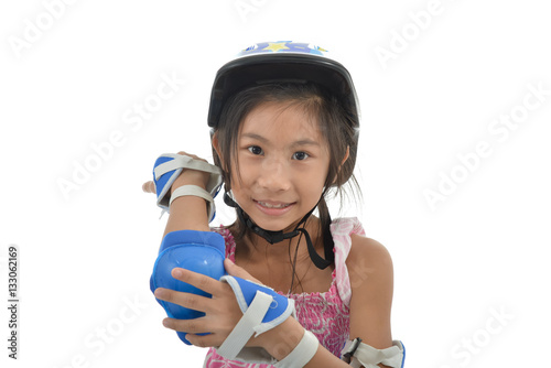 Happy Asian girl wearing hand and headguard for playing roller b