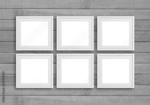 Group of six white photo frames on grey panels wall, gallery style decor mock up
