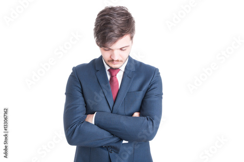 Young man wearing suit standing with arms crossed
