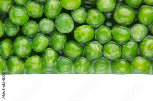 Border of wet fresh  green peas in water closeup on white background. Isolated. Healthy vitamin food. © finepoints