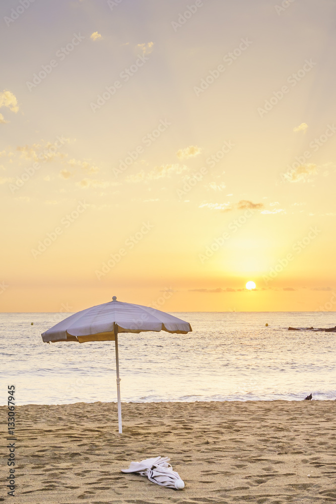 Beach umbrella at sunrise