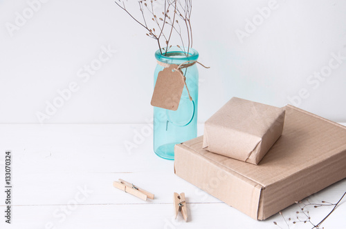 Minimal elegant composition with turquoise vase and craft boxes photo