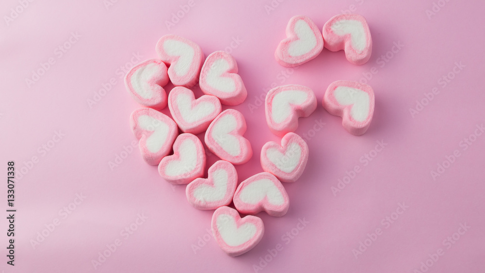 Pink heart-shaped marshmallow in with pink background