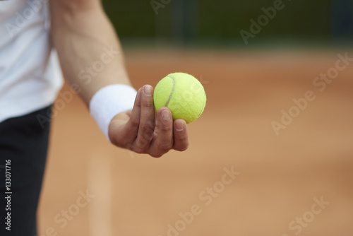 Player is holding a tennis ball. © gpointstudio