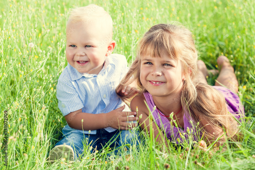 Happy brother and sister playing in park. Happy brother and sister playing in park.