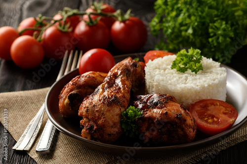 Roasted chicken legs with tomatoes and boiled rice 