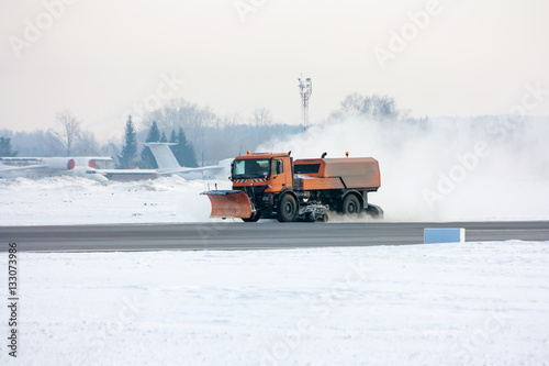Snow-removal machine cleans the main taxiway at the airport