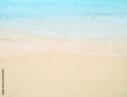 Soft wave of blue ocean on sandy beach. Background. © slonme