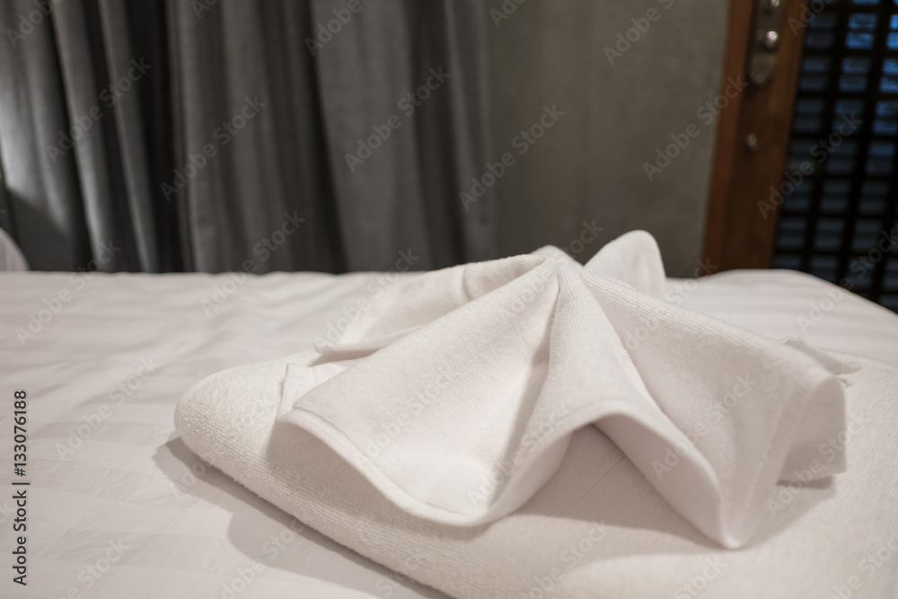 Close up, Place a towel on the bed of the hotel room. Close up, Place a towel on the bed of the hotel room.