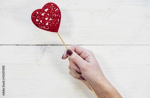 Human hand holding Valentines decoration