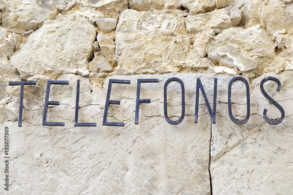 Old sign with the word telephone written in Spanish Old sign with the word telephone written in Spanish