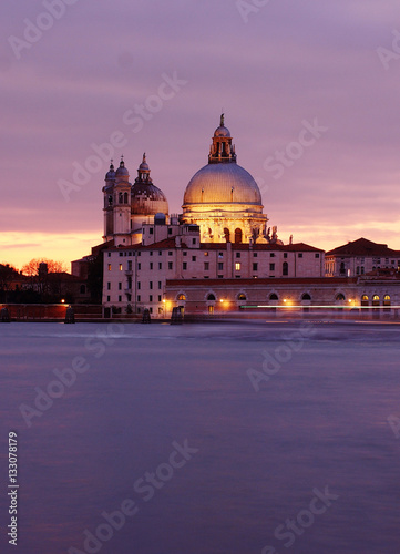 Travel in Italy - A purple sunset at the Madonna della Salute Church, Venice, Italy, view from St. George Island