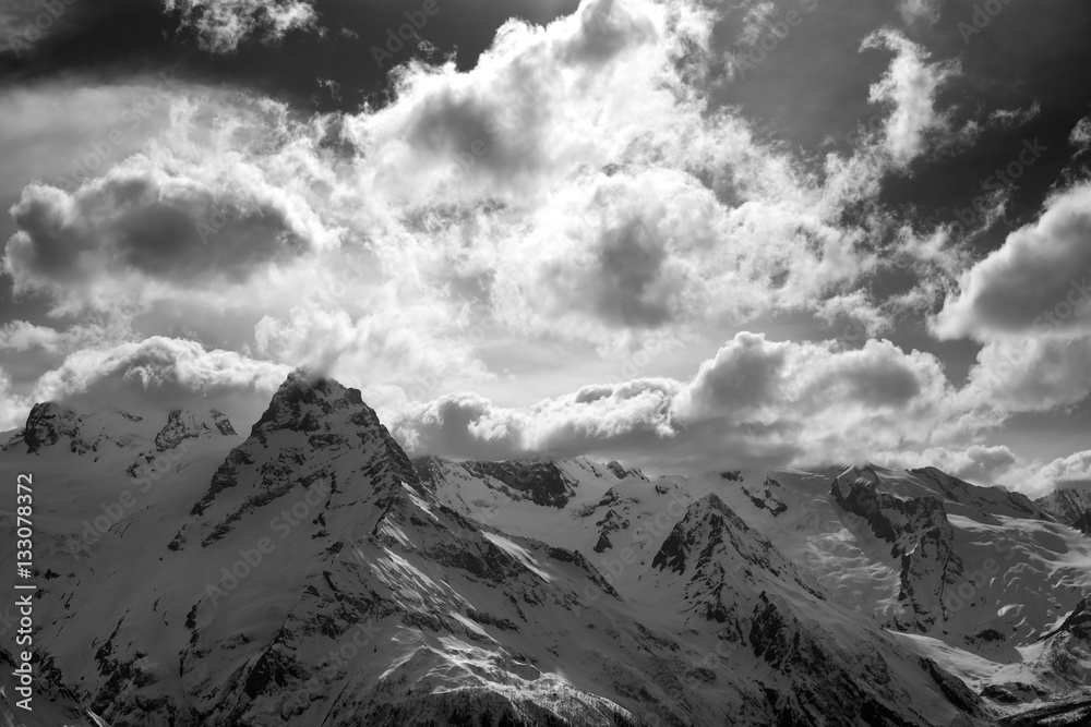 Obraz premium Black and white snow mountains in clouds