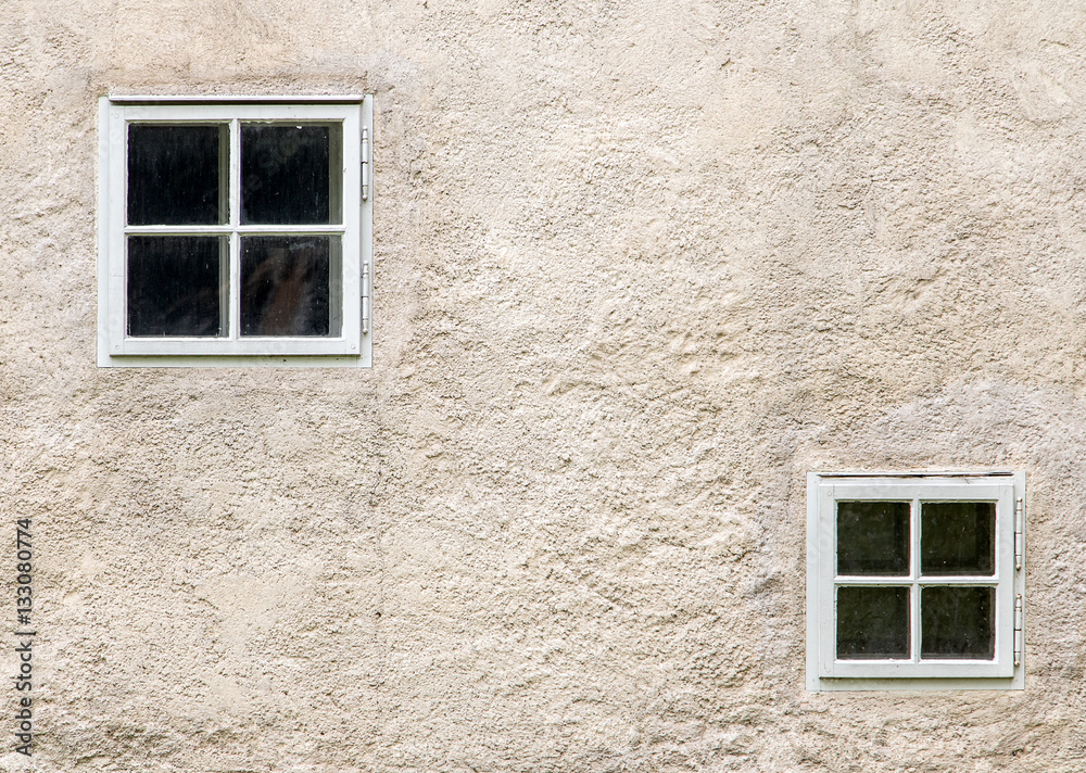 facade of an old building with small windows facade of an old building with small windows