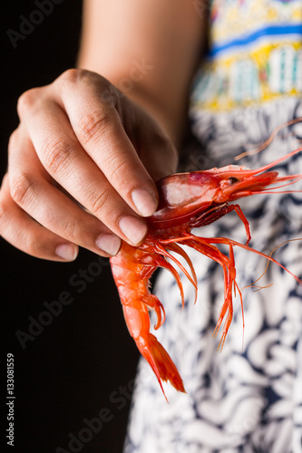 Hand holding prawn photo