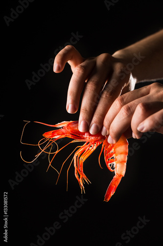 Hand holding prawn