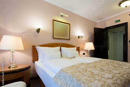 Interior of a new modern hotel double bed bedroom