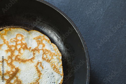 Pancake in a frying pan.