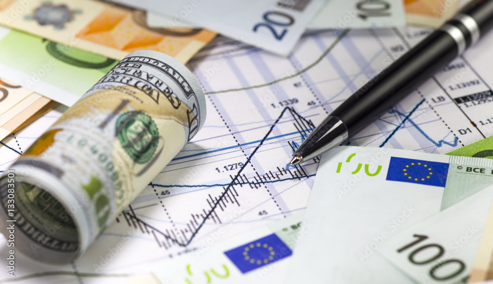 Us dollar bill and euro bills lying on the chart of dollar euro prices.Japanese candlesticks on the diagram. Pen on the graph. Concept of currencies trading. Selective shallow focus.
Us dollar bill and euro bills lying on the chart of dollar euro prices.Japanese candlesticks on the diagram. Pen on the graph. Concept of currencies trading. Selective shallow focus.