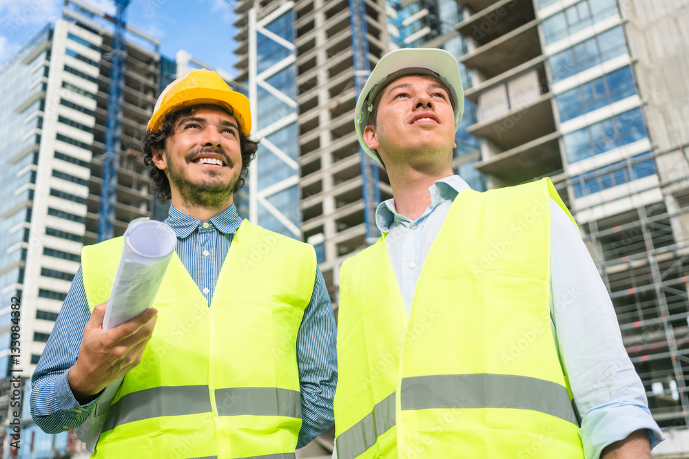 Architects supervising progress of high rise project Architects supervising progress of high rise project