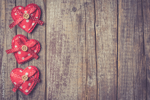 Red hearts on an old wooden table. Valentine's Day background