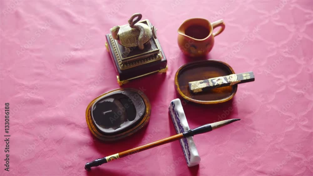 Chinese calligraphy tools on red table top view 4K
Chinese calligraphy tools on red table top view 4K