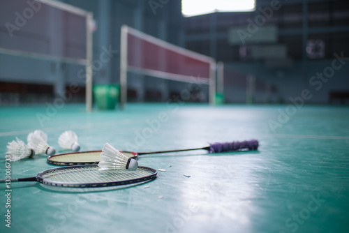 Badminton ball (shuttlecock) and racket on court floor