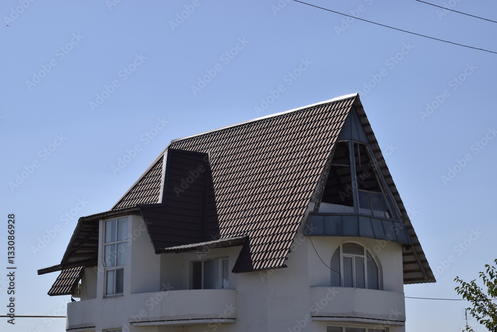 Detached house with a roof made of steel sheets. Detached house with a roof made of steel sheets.